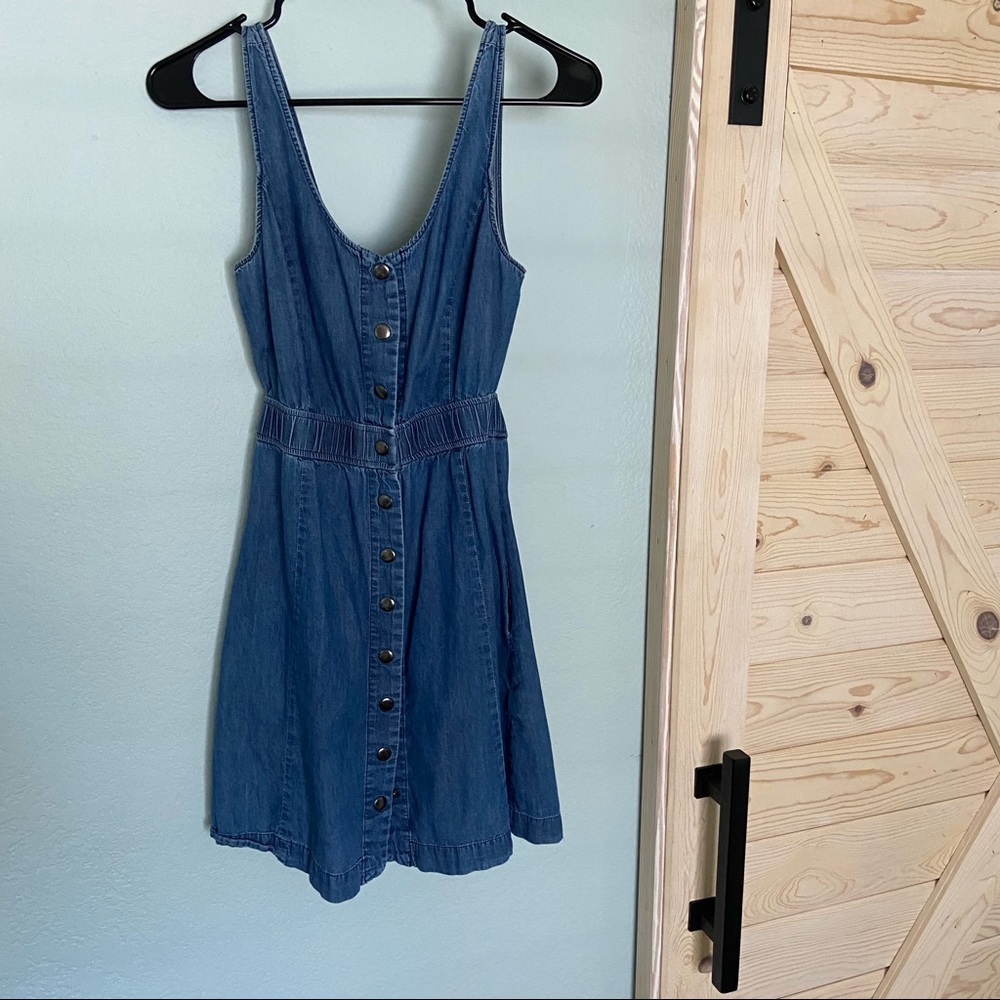 Jean button up mini dress with cut out back detail and pockets!